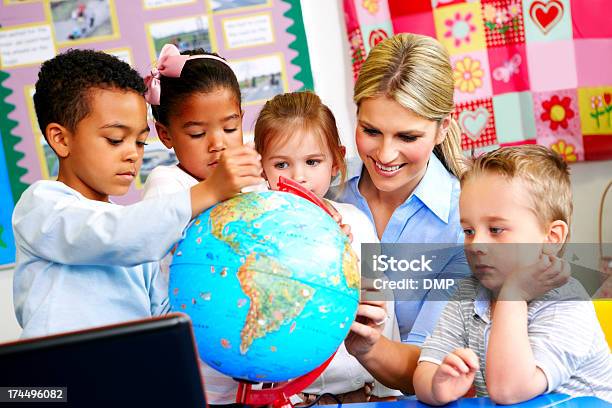 Young Teacher Explaining The World To Preschoolers Stock Photo - Download Image Now - Globe - Navigational Equipment, Planet - Space, Elementary Student
