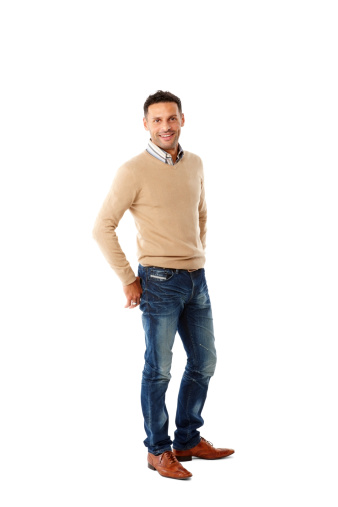 Full length image of handsome young guy standing casually on white background