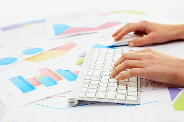 istock Woman typing on keybord with charts around her 174496671