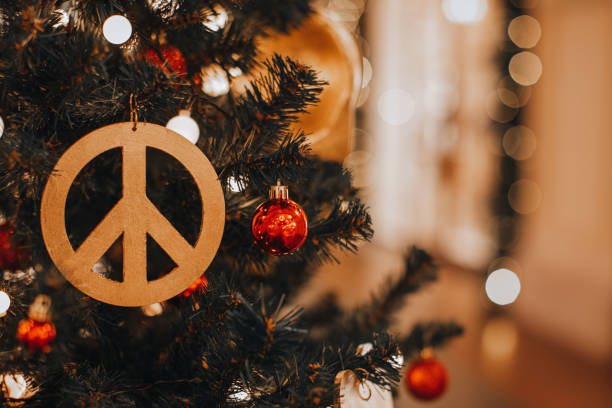 istock Christmas decoration with hippie icon figurine hanging on a Christmas tree. 1744970850