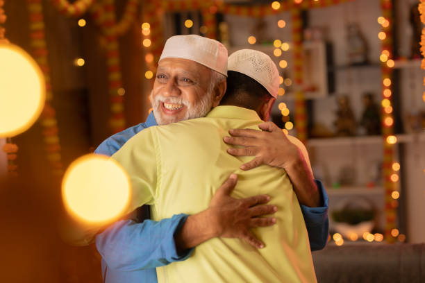 istock Father and son in skull caps embracing during Eid-Ul-Fitr 1744985446