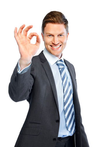 Portrait of happy young business man showing an OK sign isolated on white background