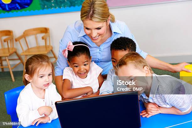 Красивые Учитель И Студенты Используя Ноутбук В Детский Сад — стоковые фотографии и другие картинки Малыш