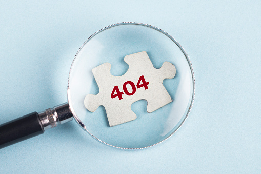 404 on puzzle piece with magnifying glass