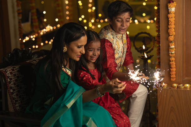 istock Mother with children playing with sparklers at home 1745005283