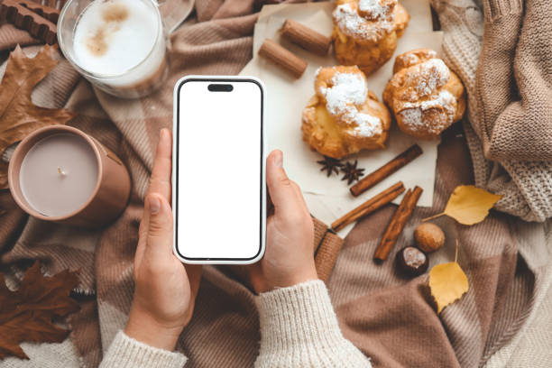 istock Phone with an isolated screen in hands, autumn mood 1745020417