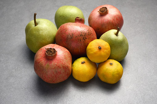 Assortment of fruits, fresh organic pomegranate, pear, tangerine