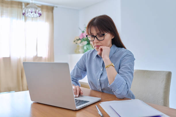 istock Middle aged business woman working on computer in home office 1745034881