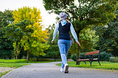 Beautiful mid adult woman walking in city park