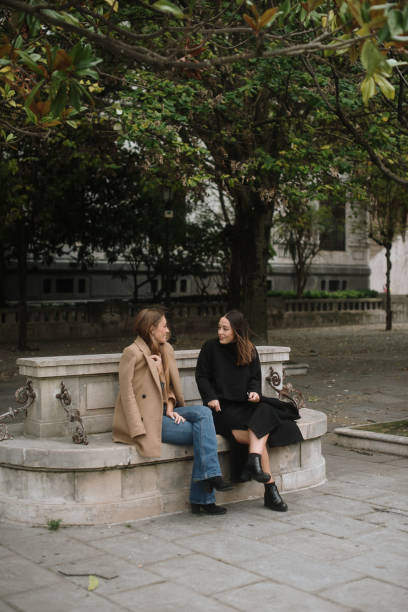 istock Two women hanging out in a city park 1745050532