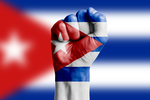 Cartoon Hand holding a flag of Cuba. 3d illustration.