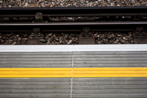 Yellow line on a train platform, designed to warn people to stand back to avoid being hit by a train