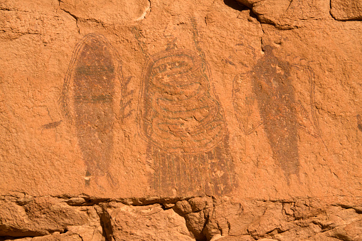 High on a cliff face, “intestine man” Barrier Canyon style pictographs remain in sandstone cliffs on public lands just outside Canyonlands National Park in Moab, Utah.