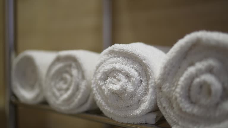 Close-up of a rolled towels on the shelf at the home