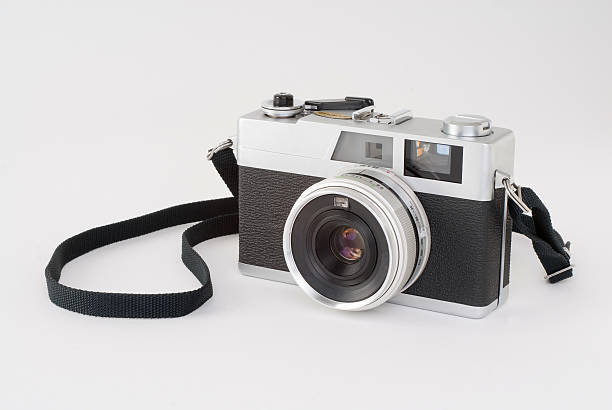 Black and white rangefinder camera on a white surface Image of an "old school" rangefinder. Useful image for any photographic need. strap photos stock pictures, royalty-free photos & images