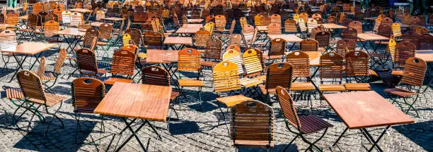 table and chairs at a typical bavarian beergarden - photo