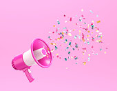 Pink megaphone with shiny confetti coming out of it