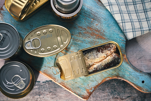 Canned fish in an iron can on white background