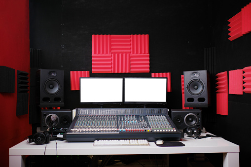 Front view of the mixing console and computer screens in the recording studio.
