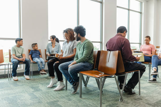 istock Diverse people fill out forms in doctor's waiting room 1745157924