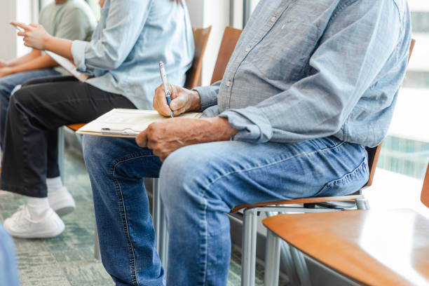 istock Low angle view senior man filling out medical forms 1745157927
