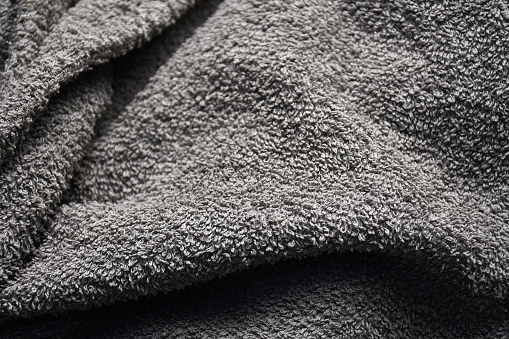 Towel fabric. Soft towel textile texture background. Wrinkled gray color fiber textile background