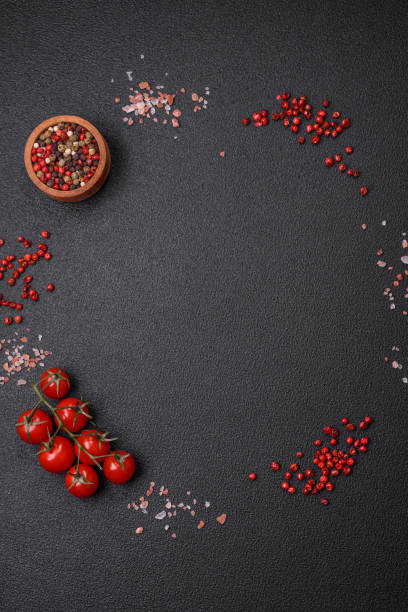 istock Ingredients salt, spices, herbs and tomatoes on a dark concrete background 1745163868