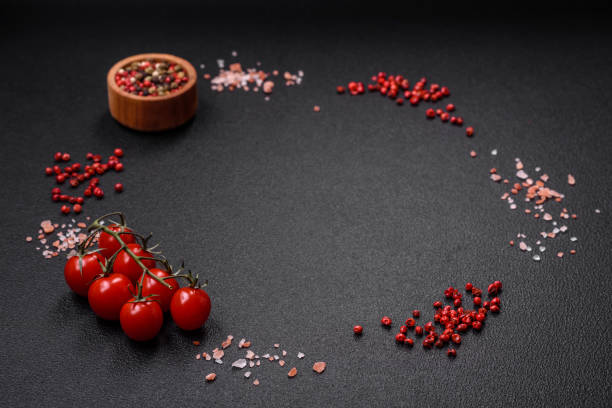 istock Ingredients salt, spices, herbs and tomatoes on a dark concrete background 1745163879