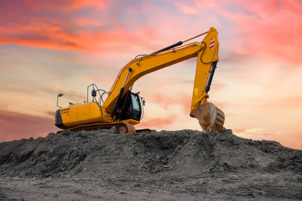 istock Excavator during earthmoving at construction site. Backhoe digging the ground for the foundation and for laying sewer pipes district heating. Earth-moving heavy equipment 1745180120