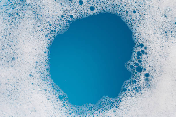 istock Detergent foam bubble on water. Blue background, Soap sud 1745221754