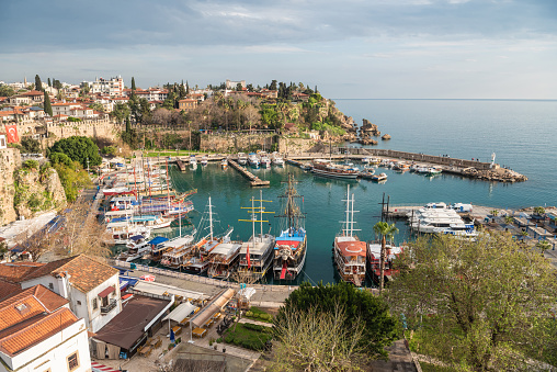 The harbour in Kaleici historic district in Antalya, Turkey. View with tourist boats and fortress walls.