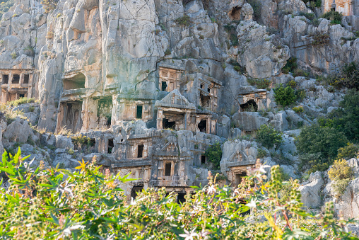 Lycian rock tombs of Myra ancient site in Antalya province of Turkey. Lycian rock-cut tombs are in the form of temple fronts carved into the vertical faces of cliffs.