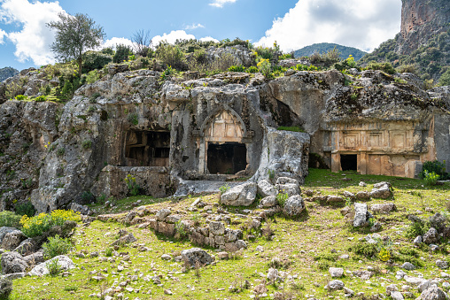 Rock tombs at Pinara ancient site in Mugla province of Turkey. The rock tombs date to about 4th century BC. Pinara was a large city of ancient Lycia.