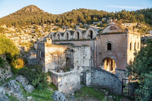 Ruined Taksiyarhis upper church of Kayakoy (Levissi) abandoned village near Fethiye in Mugla province of Turkey. The church dates from the 19th century. Levissi was deserted by its mostly Greek inhabitants in the general exchange of populations supervised by the League of Nations in 1923 after the Turkish Greco-Turkish War of 19191922.