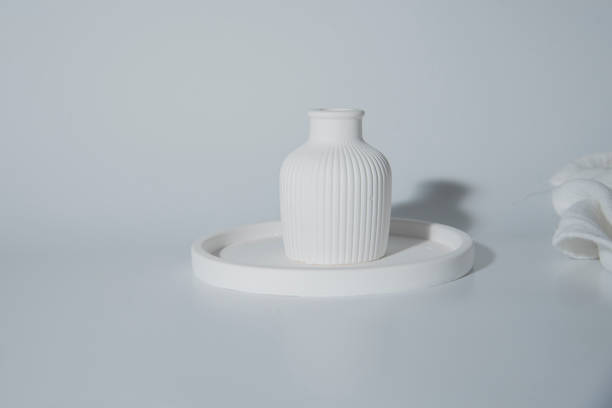 istock Small white ceramic vase.handmade symbolic ceramic figurines.Cozy home natural eco decor 1745266366