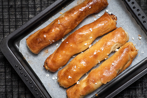 Cheese  and bacon sausage rolls isolated on white