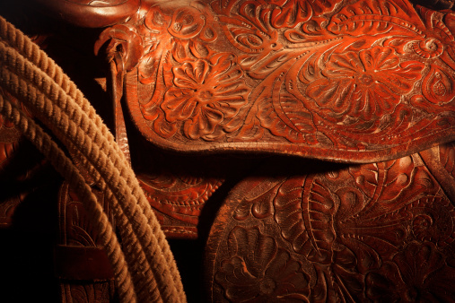 Close-up of hand tooled leather saddle with lariat