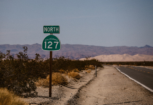 Driving through the vast wilderness of Death Valley. Empty roads in the beautiful nature.