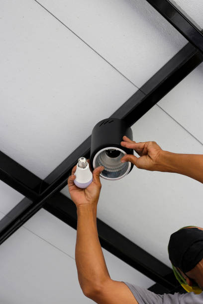 istock Hands of an electrician installing a light on the ceiling. 1745382580
