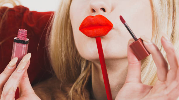 istock Woman applying lipstick or lip gloss 1745426561