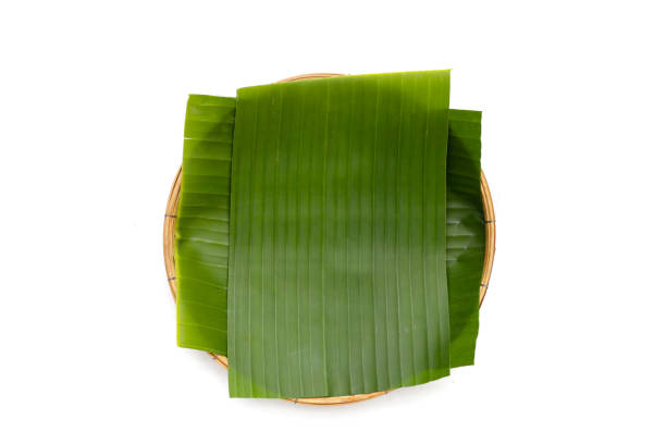 istock Banana leaves in bamboo weave plate on white background. 1745436481