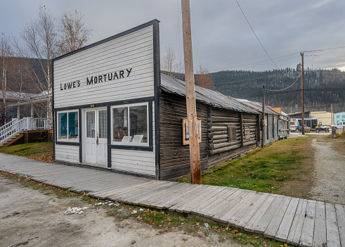 Dawson City, Yukon, Canada – October 05, 2023:  Exterior of the historic lumber and log Lowe’s Mortuary