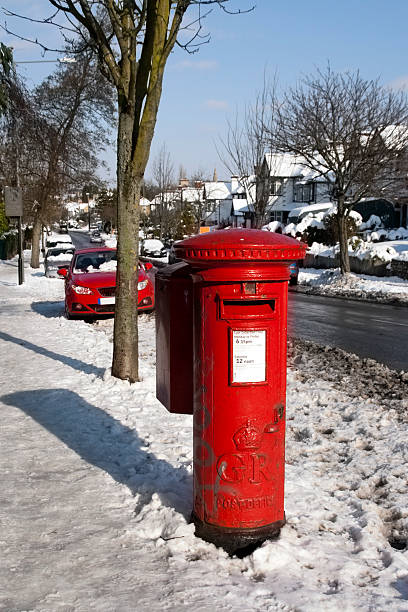 istock Red post box on snowy street 174544492