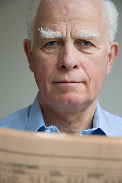 Man and newspaper stock photo