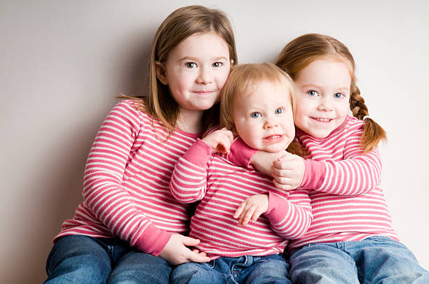 istock Color Image of Three Matching Sisters Hugging Each Other 174545392