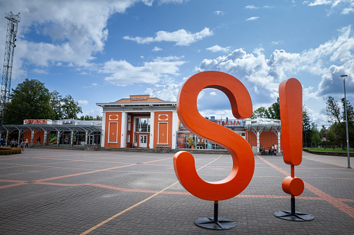 Picture of a sign of the tourism office of Sigulda in front of Sigulda train station. Sigulda is a town in the Vidzeme region of Latvia, 53 kilometres from the capital city Riga.