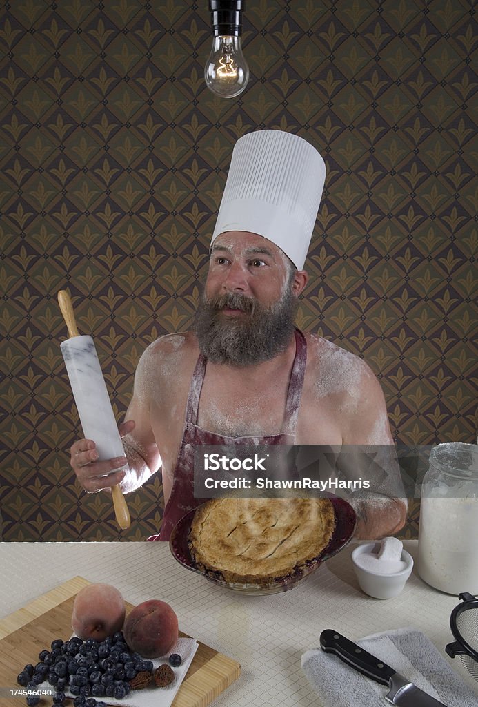 Risa mirando sin camisa guy cocinar pie - Foto de stock de Pastel de melocotón libre de derechos