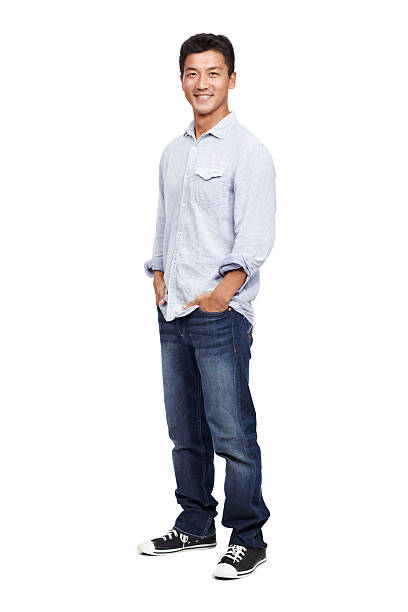 I feel relaxed and confident about myself Confident and handsome young Asian man smiling while isolated on white - copyspace hands in pockets stock pictures, royalty-free photos & images
