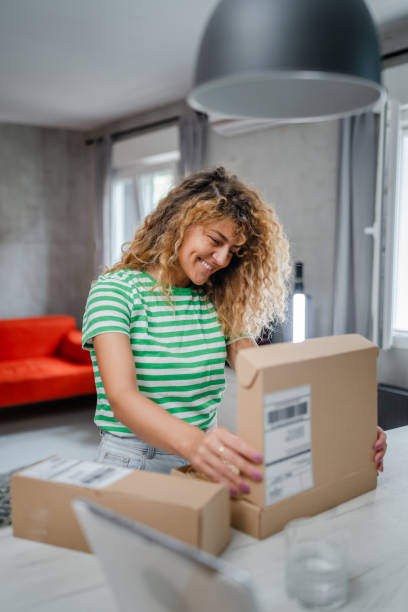 istock one happy woman open mail cardboard package box present at home 1745476186