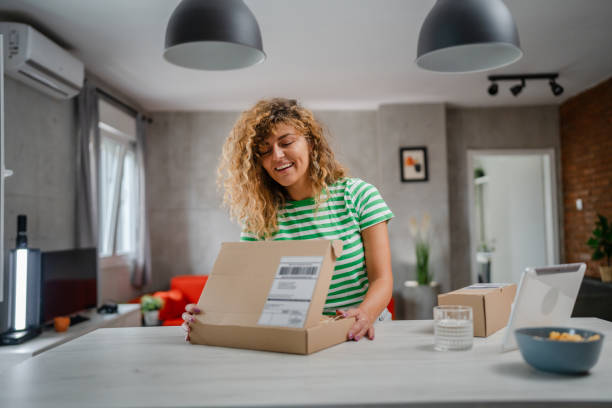 istock one happy woman open mail cardboard package box present at home 1745477273